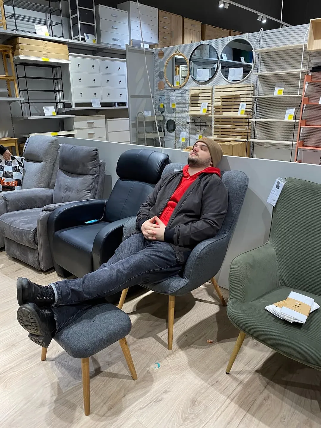 Sleeping on a chair in a furniture store.